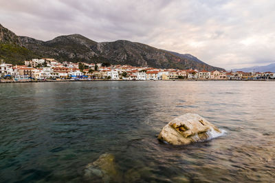 Scenic view of sea and buildings against sky