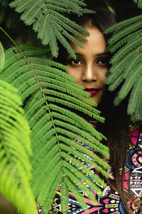 Portrait of woman with green leaves