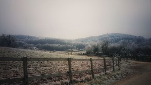 Fence in winter against sky