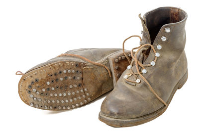 Close-up of old shoes against white background