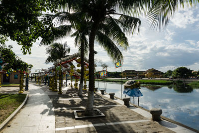 Scenic view of lake against sky in city