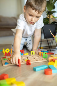 Boy playing with toys at home