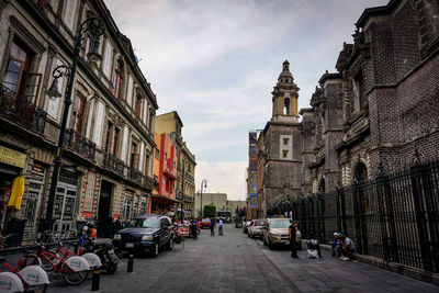 Street amidst buildings in city against sky