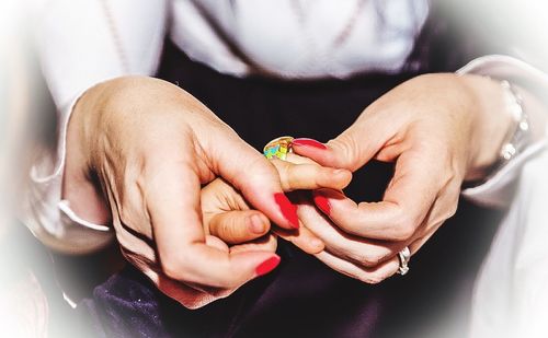 Close-up of cropped hand holding cigarette