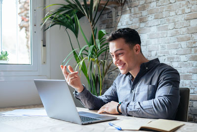 Young man using laptop at office