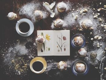 Directly above shot of breakfast and book on messy table