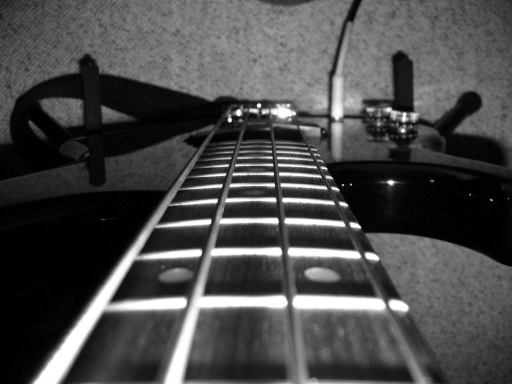 indoors, music, close-up, musical instrument, arts culture and entertainment, table, still life, technology, musical instrument string, focus on foreground, selective focus, musical equipment, high angle view, guitar, no people, metal, acoustic guitar, lighting equipment, shadow, illuminated