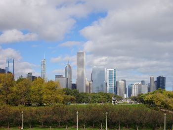 View of cityscape against cloudy sky