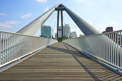 View of footbridge against cloudy sky