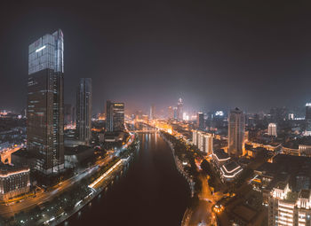 High angle view of illuminated city buildings at night