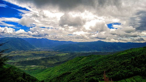 Scenic view of mountains against cloudy sky