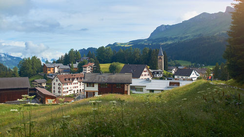 Houses and mountains against sky