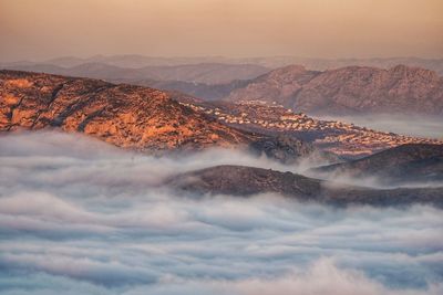 Aerial view of mountain against sky during sunset