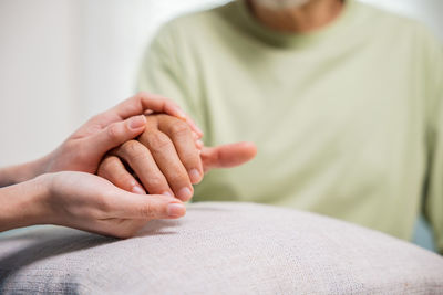 Midsection of man holding hands