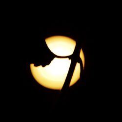 Close-up of illuminated lamp in dark room