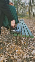 Man sitting on bench in park during autumn