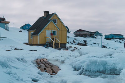 House on snow covered landscape