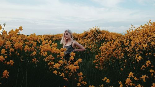 Young woman standing on field at farm