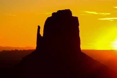 Silhouette of statue at sunset