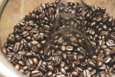 Close-up of coffee beans in bowl on table