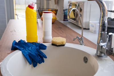 Cropped hand of person washing hands in sink