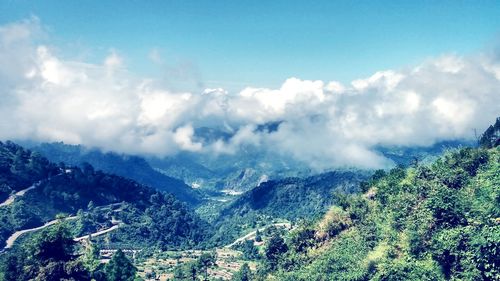 Scenic view of mountains against blue sky