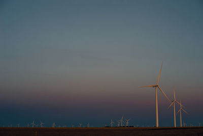 Wind turbines against sky