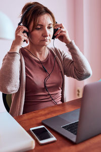 Woman working talking doing her job remotely during video chat phone call on laptop from home