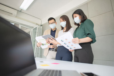 Women and man working with digital tablet