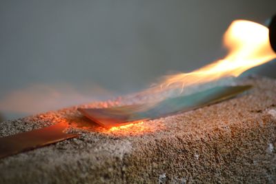 Close-up of bonfire against sky during sunset