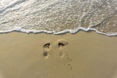 High angle view of footprints on beach