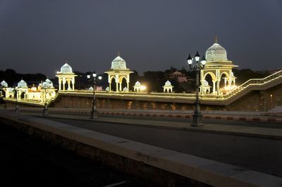 Illuminated building against sky at night