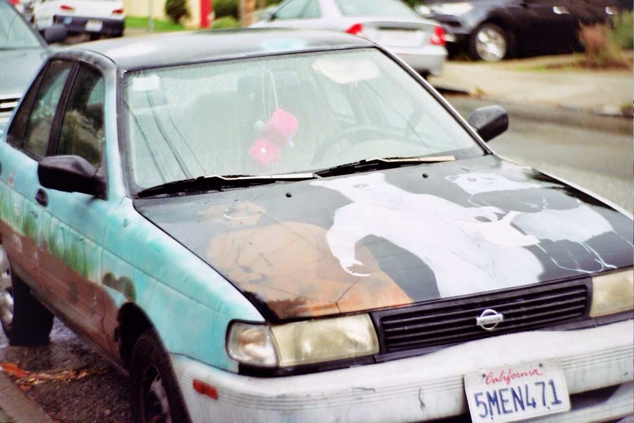 car, transportation, close-up, land vehicle, mode of transport, still life, focus on foreground, no people, day, plastic, stationary, variation, selective focus, stack, abandoned, outdoors, high angle view, street, group of objects, container