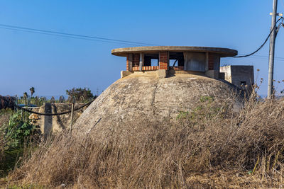 Built structure on field against clear sky