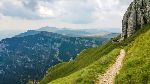 Scenic view of mountains against cloudy sky