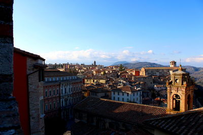 Buildings in city against blue sky