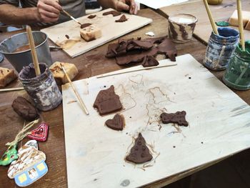 Cropped hand of person preparing food on table