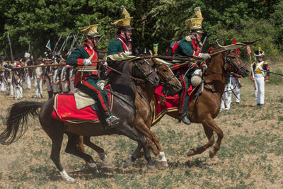 People riding horse cart