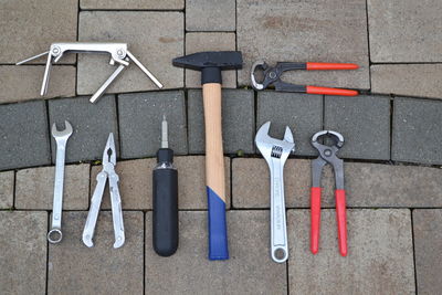 High angle view of work tools on paved street