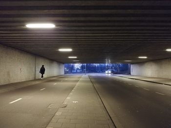 Man walking in illuminated corridor