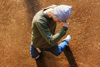 High angle view of man sitting outdoors