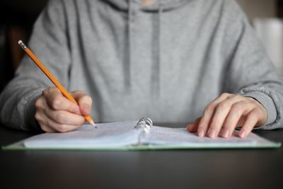 Midsection of man working on table