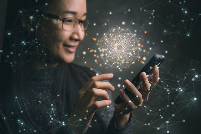 Young woman using mobile phone at night