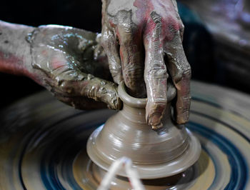 Man working on pottery wheel