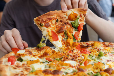 Midsection of man having pizza