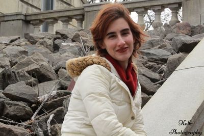 Portrait of smiling young woman standing outdoors