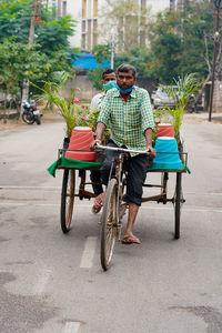 Portrait of man riding bicycle on road