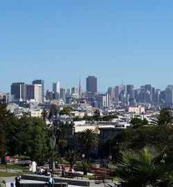 Buildings in city against blue sky