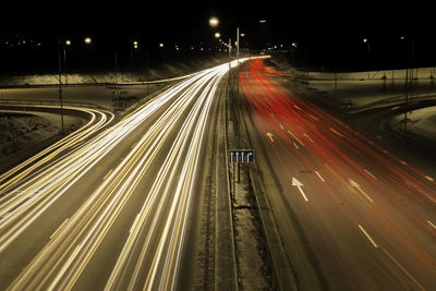 High angle view of light trails on highway at night