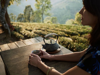 Woman drinking tea in garden